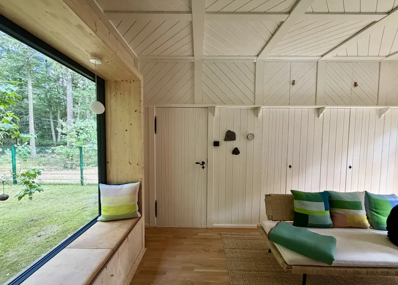 Wohnraum mit großem Sitzfenster zum Garten